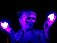 Masked Woman Holding Glowing Purple Cubes